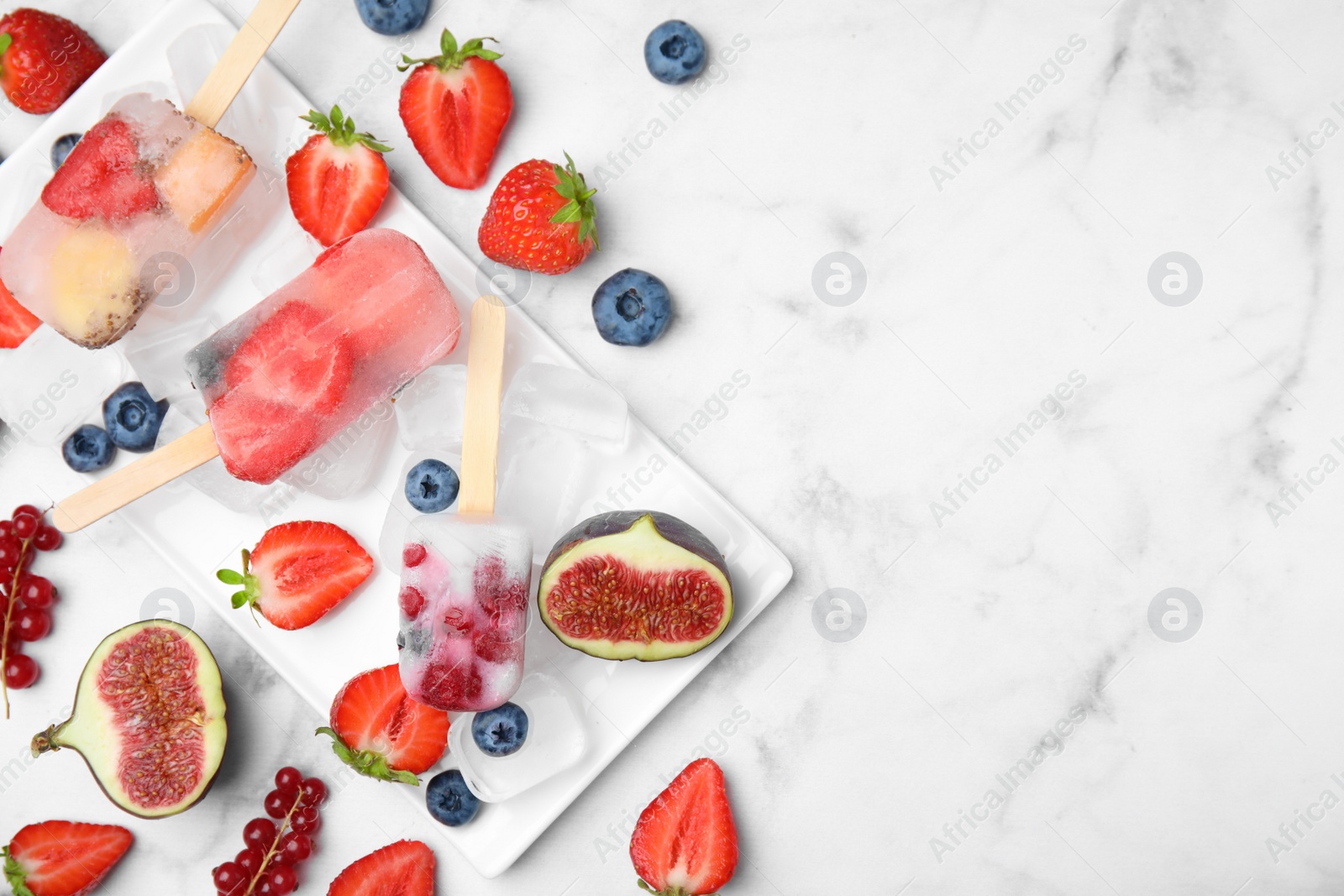 Photo of Flat lay composition with fruit and berry ice pops on light table. Space for text