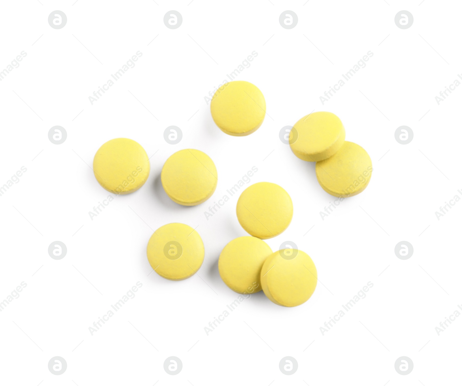 Photo of Many yellow pills isolated on white, top view