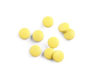 Many yellow pills isolated on white, top view