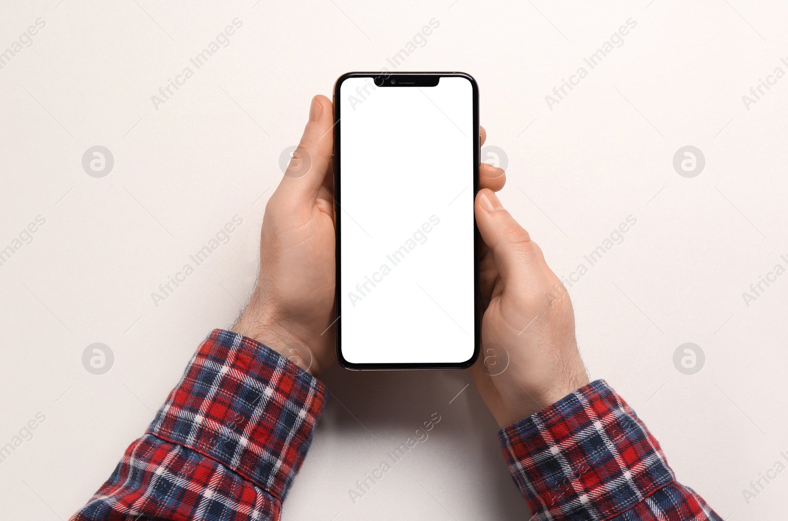 Photo of Man with smartphone on white background, top view