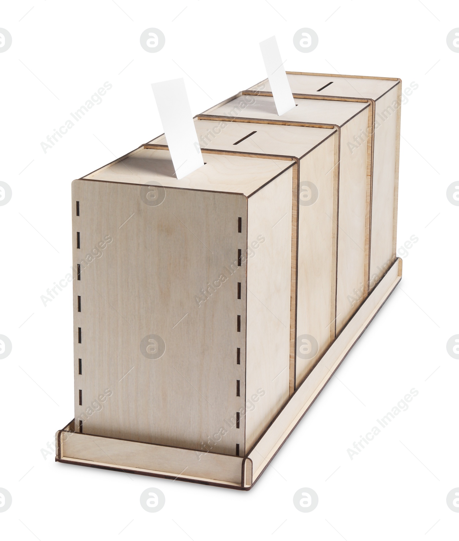 Photo of Wooden ballot boxes with votes isolated on white