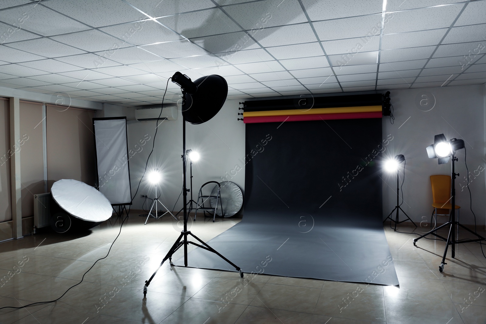 Photo of Interior of modern photo studio with professional lighting equipment