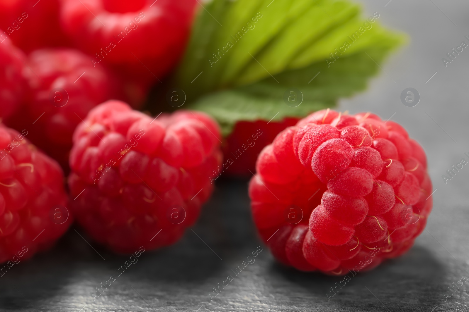 Photo of Ripe aromatic raspberries on table, closeup