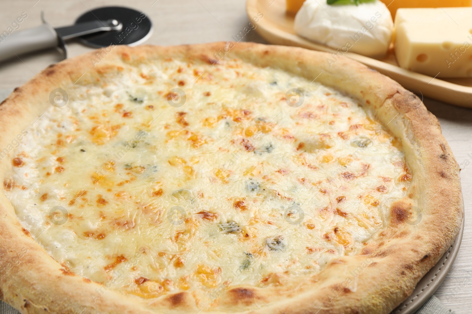 Photo of Delicious cheese pizza on table, closeup view