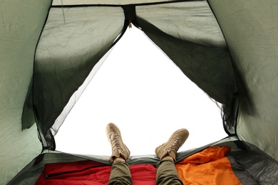 Photo of Closeup of female in camping tent on white background, view from inside