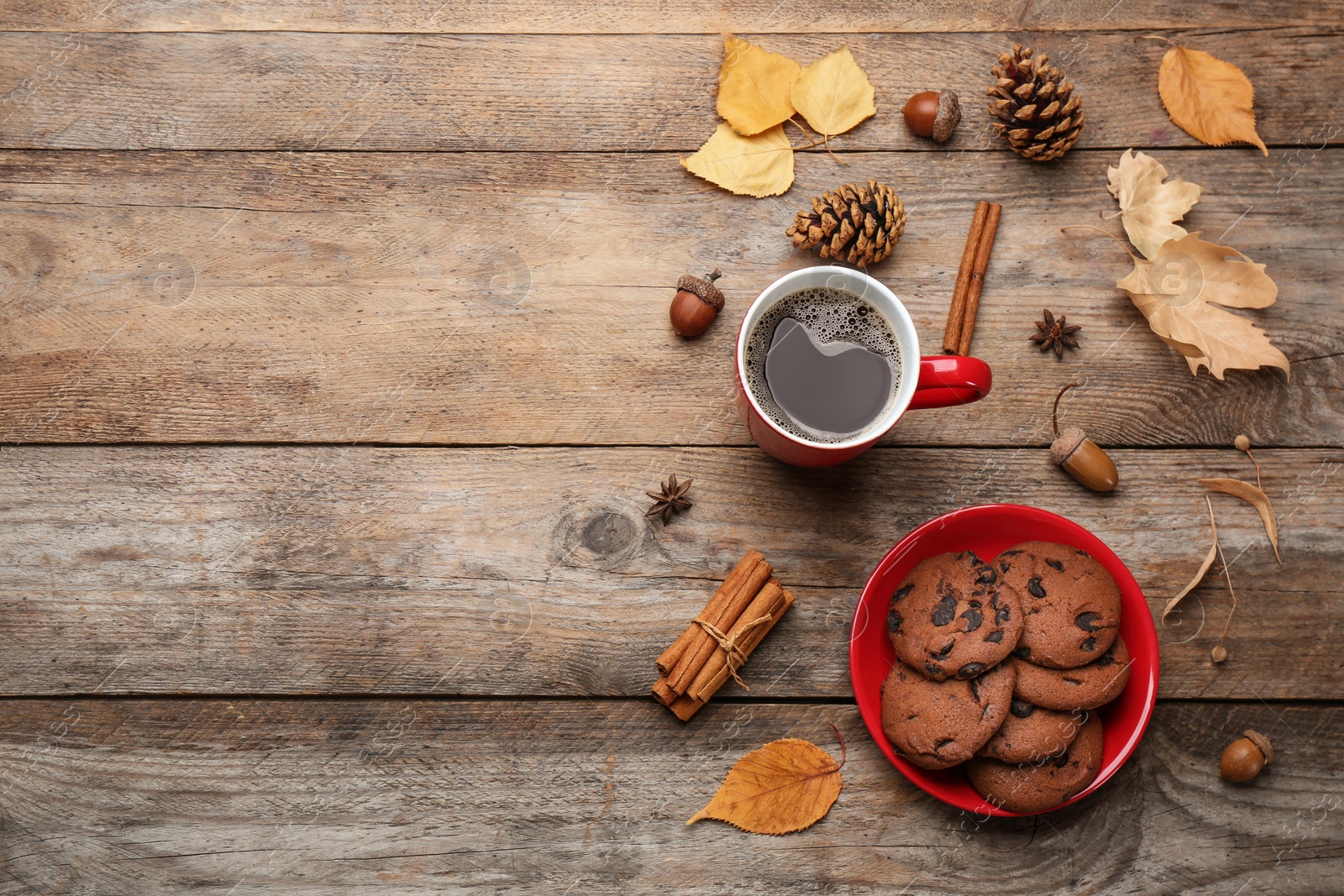 Photo of Flat lay composition with cup of hot drink on wooden table, space for text. Cozy autumn atmosphere