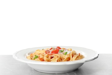 Tasty pasta on light grey marble table against white background