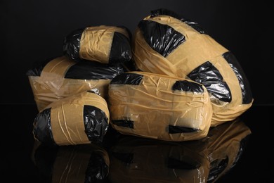 Photo of Smuggling and drug trafficking. Packages with narcotics on black mirror surface