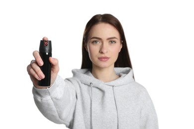 Photo of Young woman using pepper spray on white background