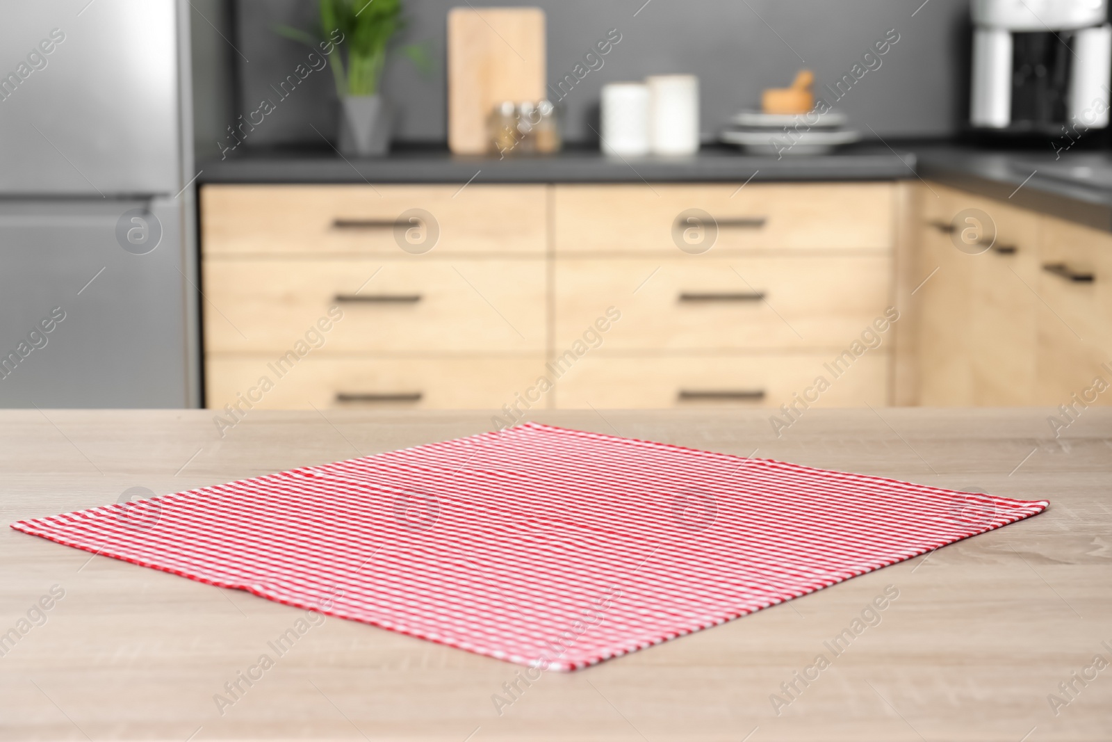 Photo of Napkin on wooden table in kitchen. Mockup for design