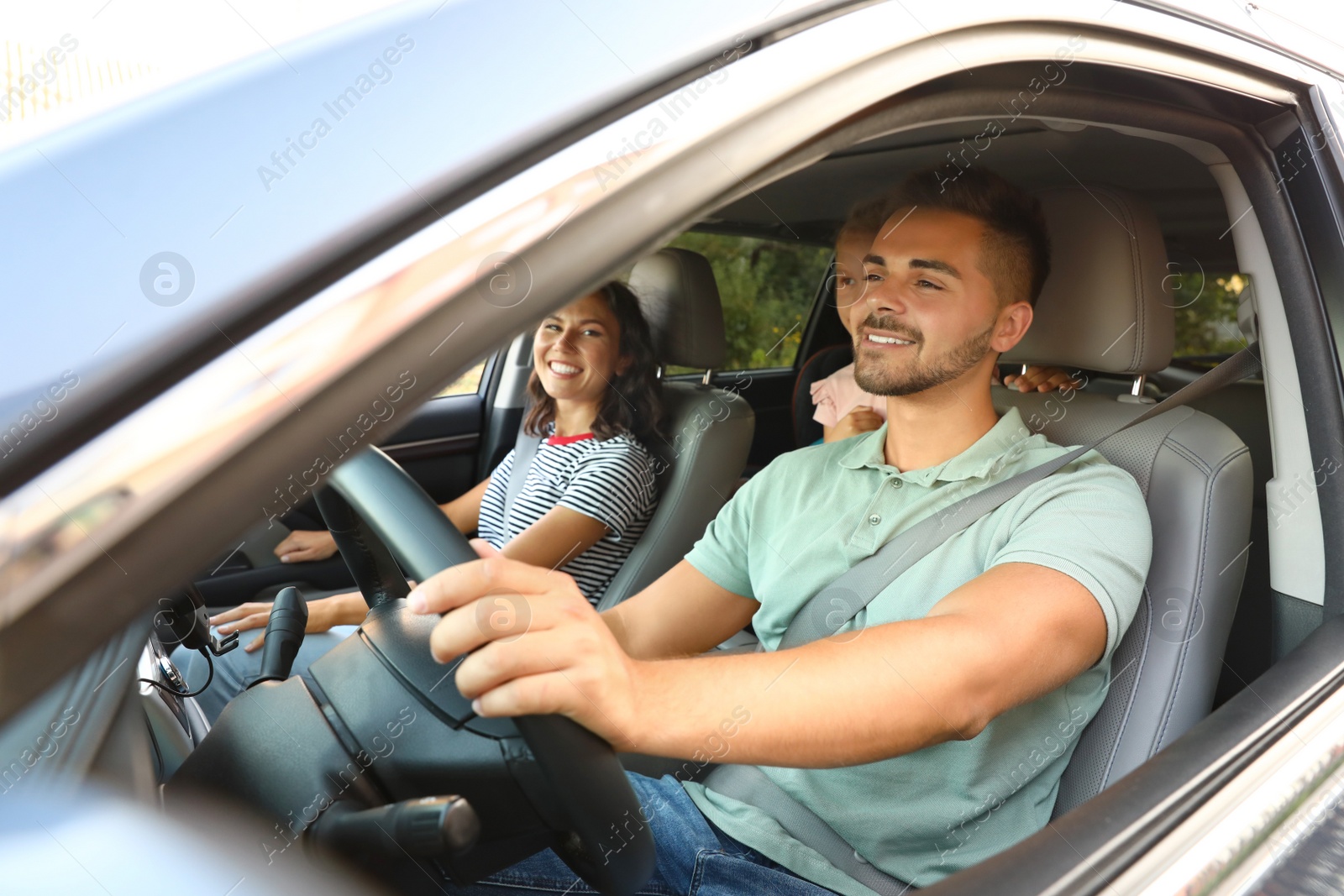 Photo of Happy family traveling by car on summer day