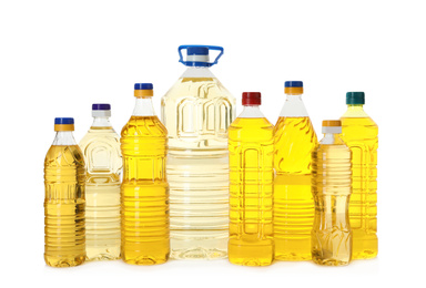 Photo of Cooking oil in different bottles isolated on white