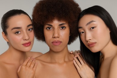 Portrait of beautiful young women on light grey background