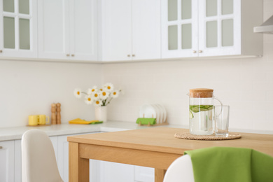 Photo of Stylish wooden table in beautiful kitchen interior