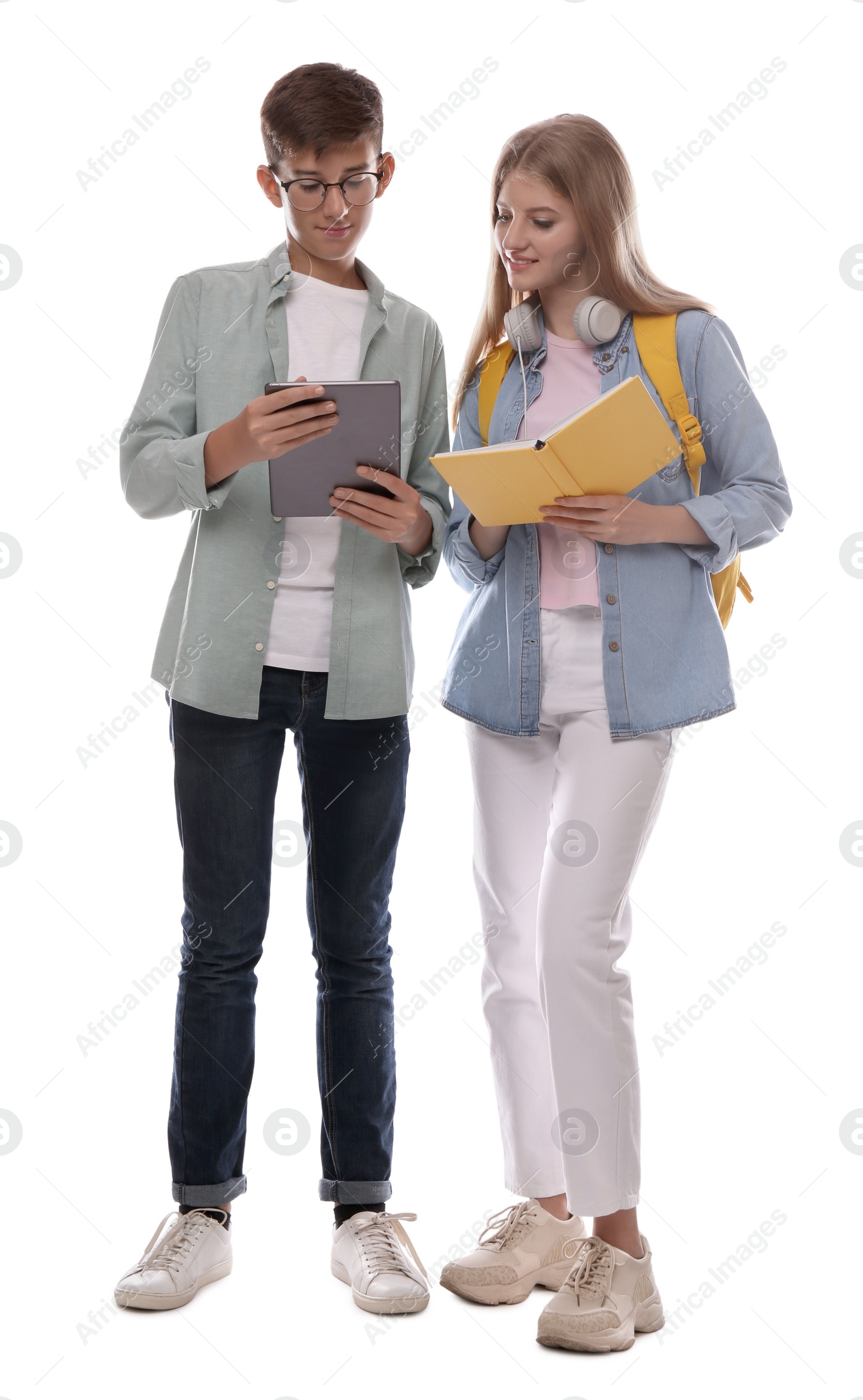 Photo of Teenage students with book and tablet on white background