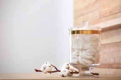 Photo of Jar with cotton pads on table indoors