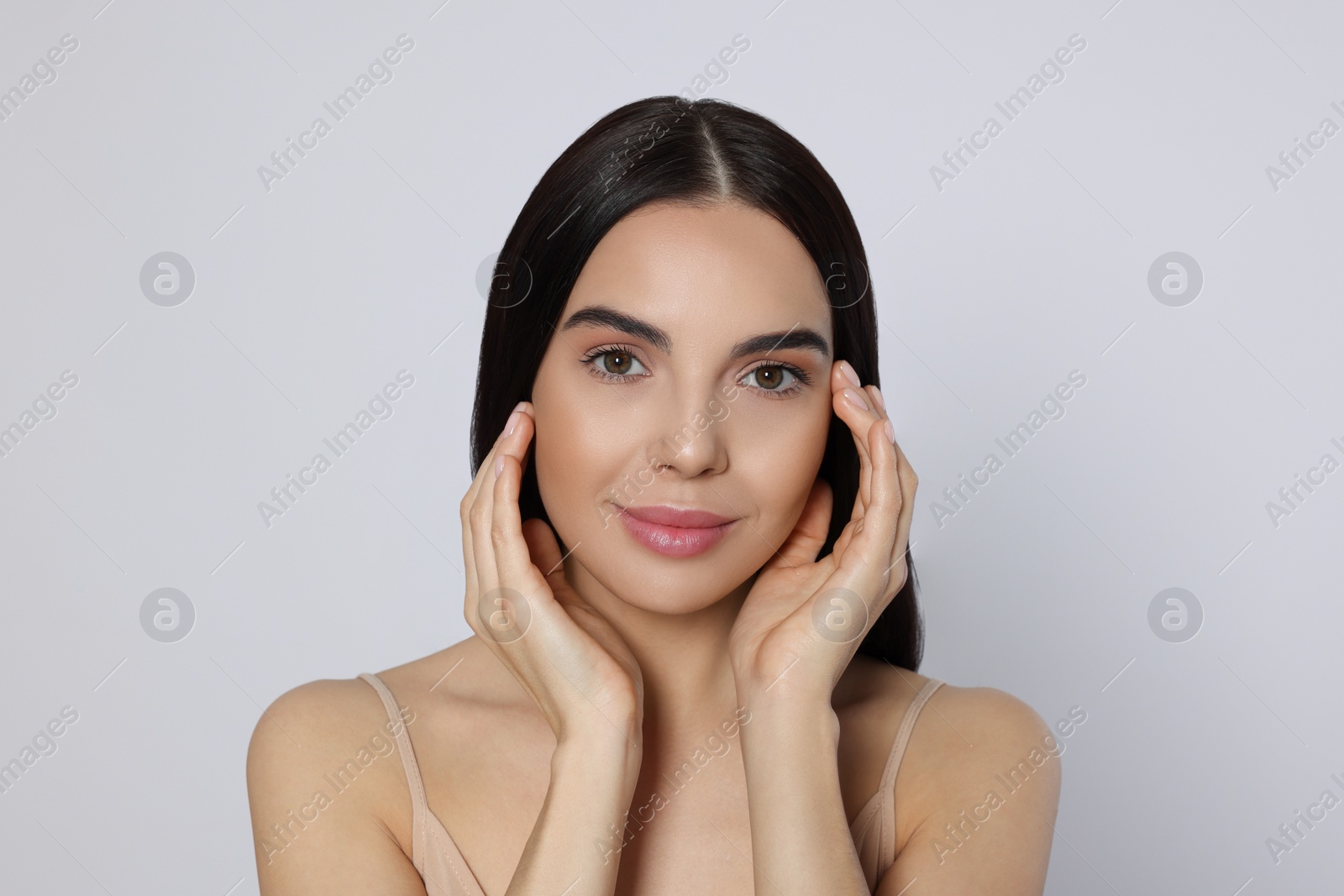 Photo of Portrait of attractive young woman on light grey background. Spa treatment