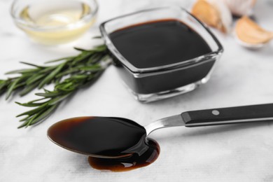 Organic balsamic vinegar and cooking ingredients on white table, closeup