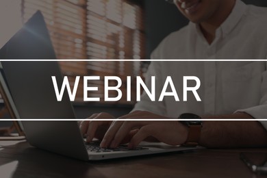 Image of Webinar concept. Man working with laptop at table indoors, closeup