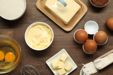 Photo of Flat lay composition with fresh butter among other products on wooden table