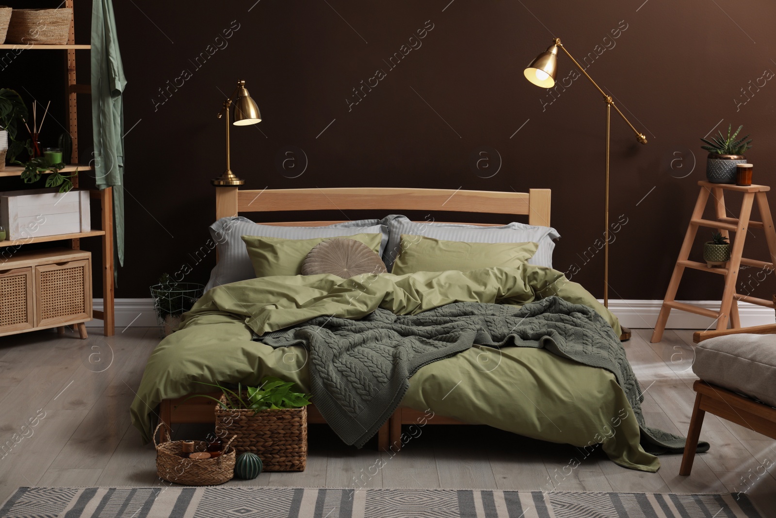 Photo of Stylish room interior with large bed and floral pictures