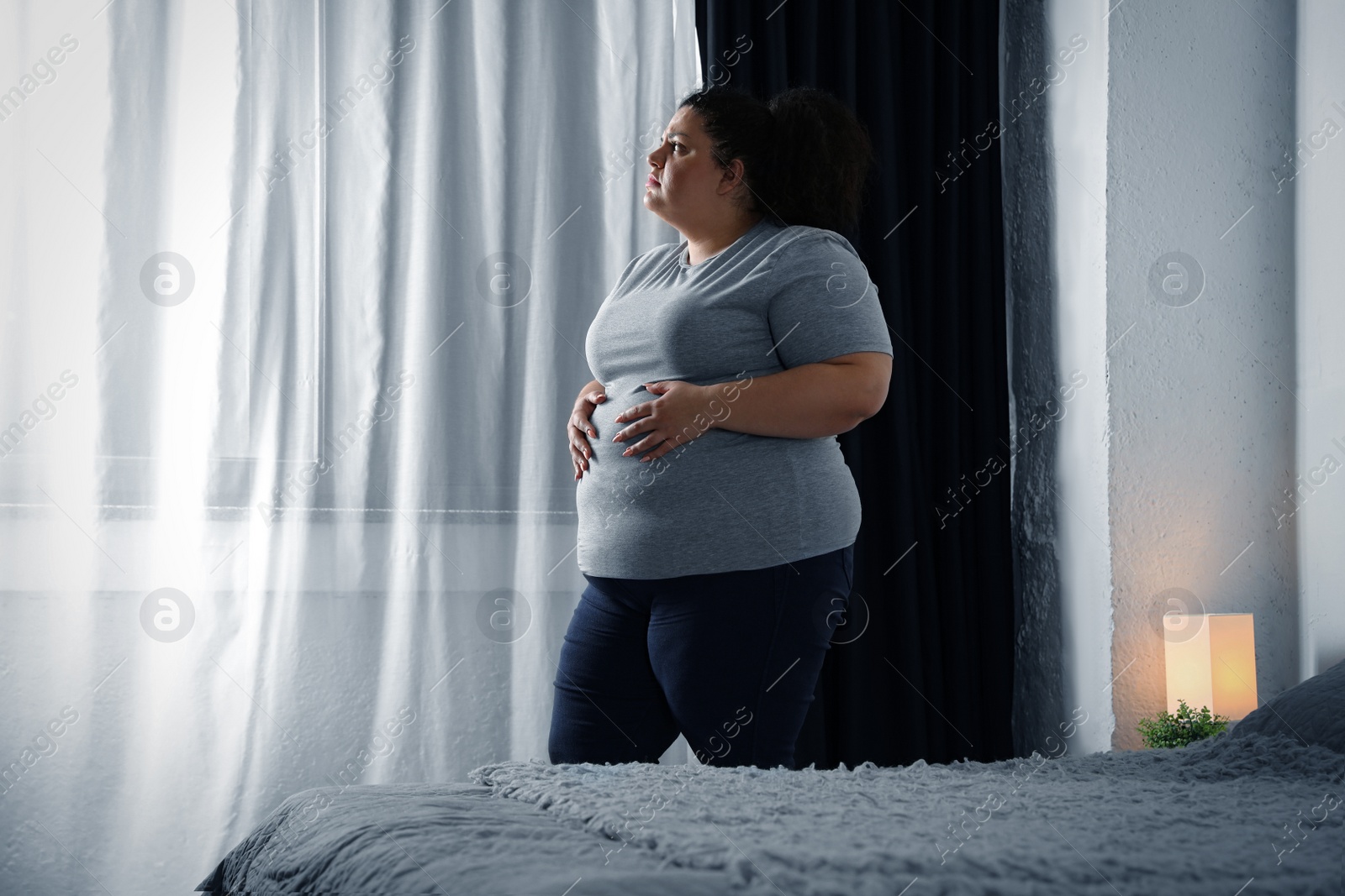 Photo of Overweight woman suffering from depression at home