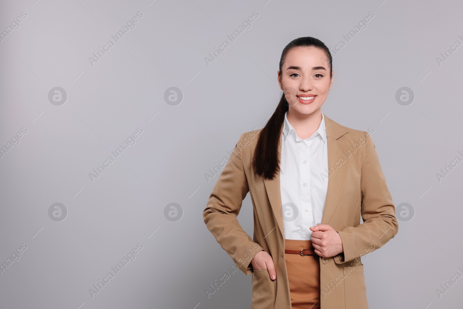 Photo of Happy real estate agent on grey background. Space for text