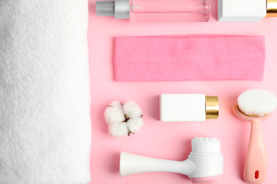 Photo of Flat lay composition with face cleansing brushes on pink background. Cosmetic tools