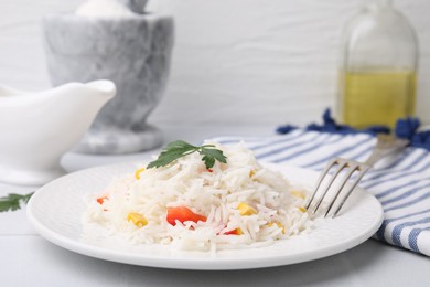 Photo of Delicious rice with vegetables and parsley served on table, closeup