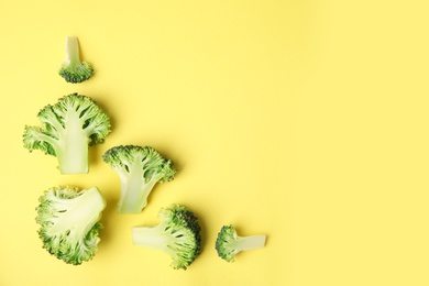 Photo of Flat lay composition with fresh green broccoli on color background. Space for text