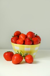 Fresh ripe juicy strawberries on white table