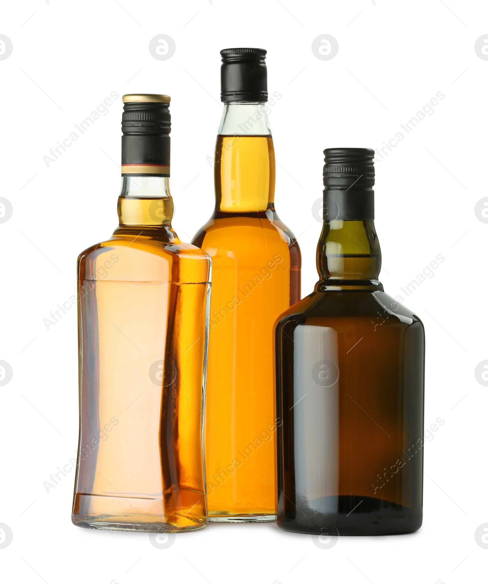 Photo of Different sorts of whiskey in glass bottles isolated on white