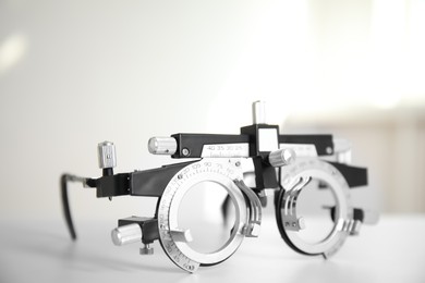 Photo of Trial frame on white table, closeup. Ophthalmologist tool