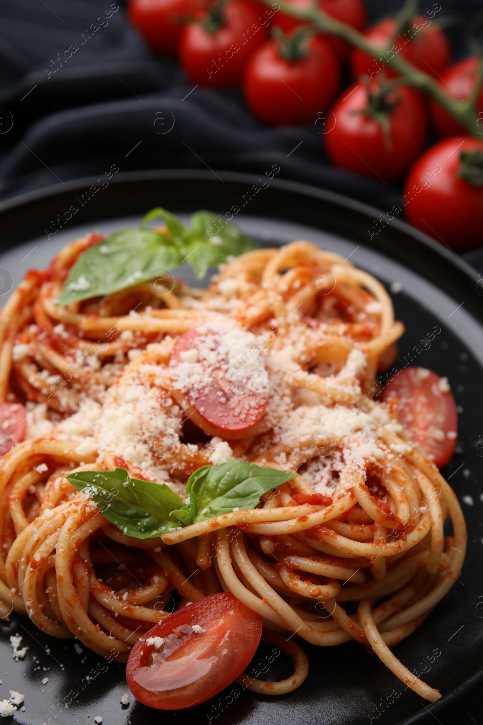 Photo of Tasty pasta with tomato sauce, cheese and basil on table, closeup