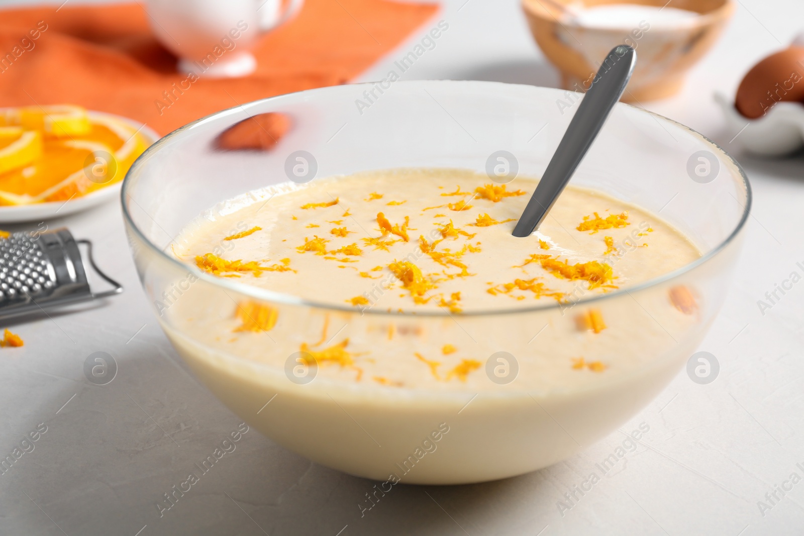 Photo of Glass bowl with batter on light table, closeup