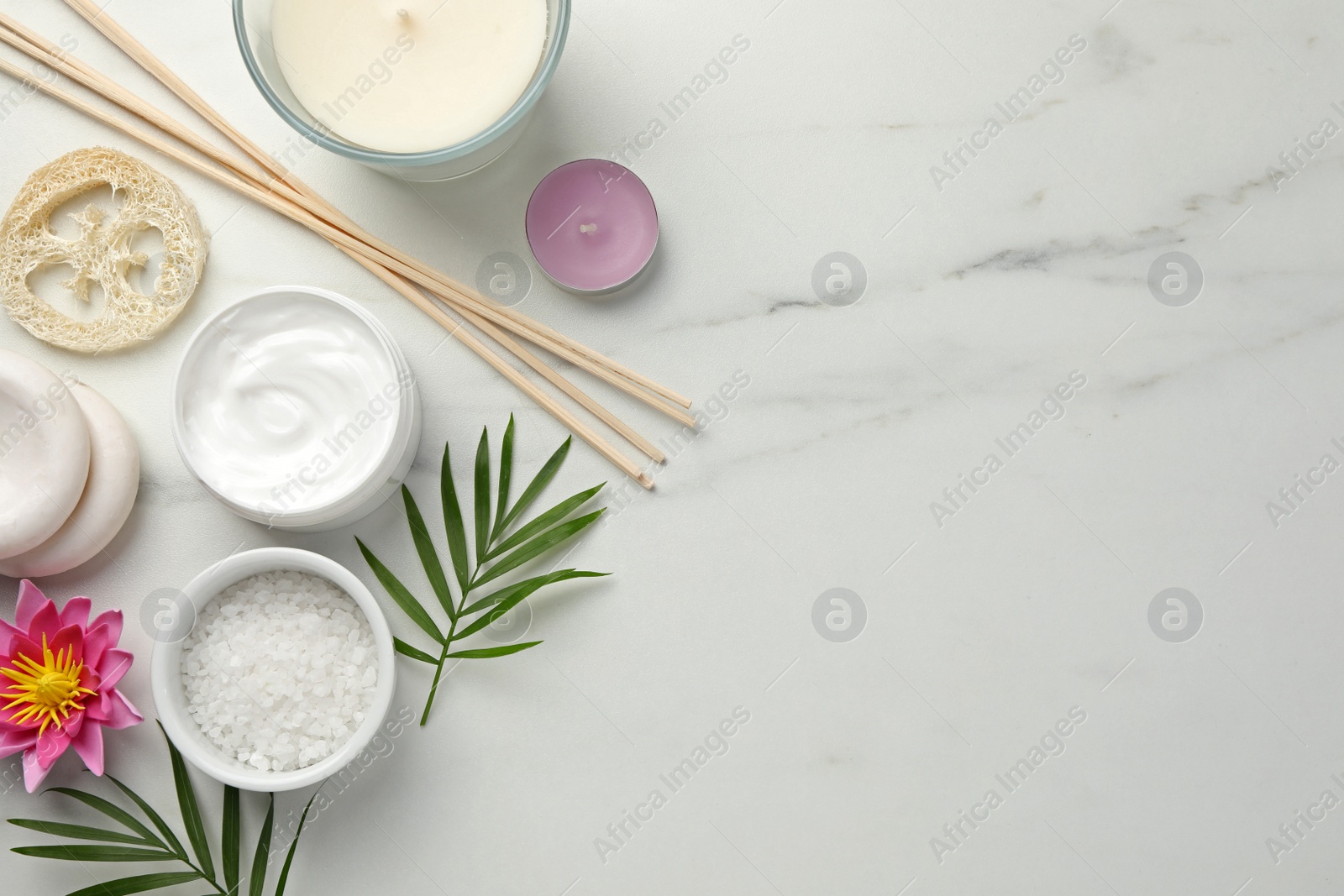 Photo of Flat lay composition with different spa products on white marble table. Space for text