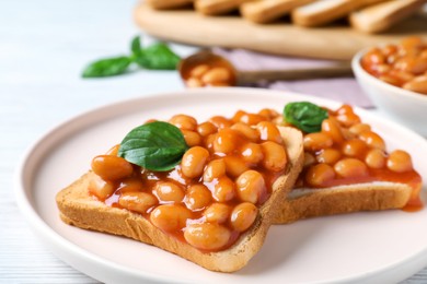 Photo of Toasts with delicious canned beans on white wooden table, closeup
