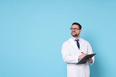 Smiling doctor with pen and clipboard on light blue background, space for text