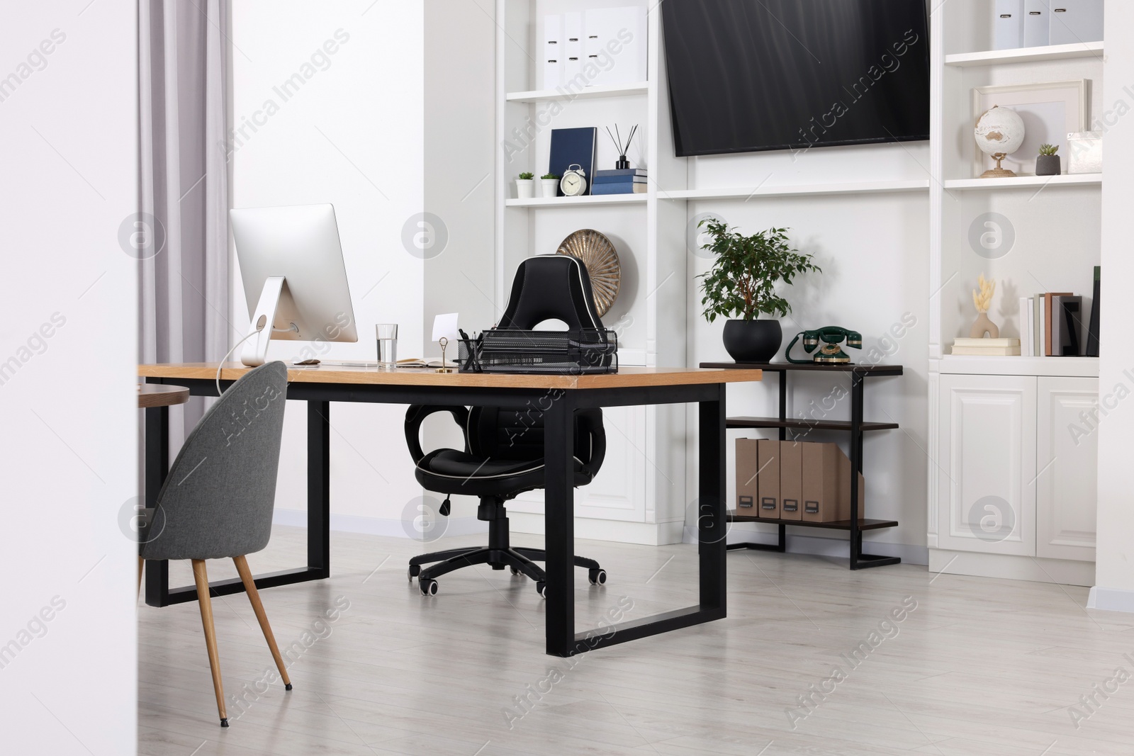 Photo of Stylish office with comfortable furniture and tv zone. Interior design