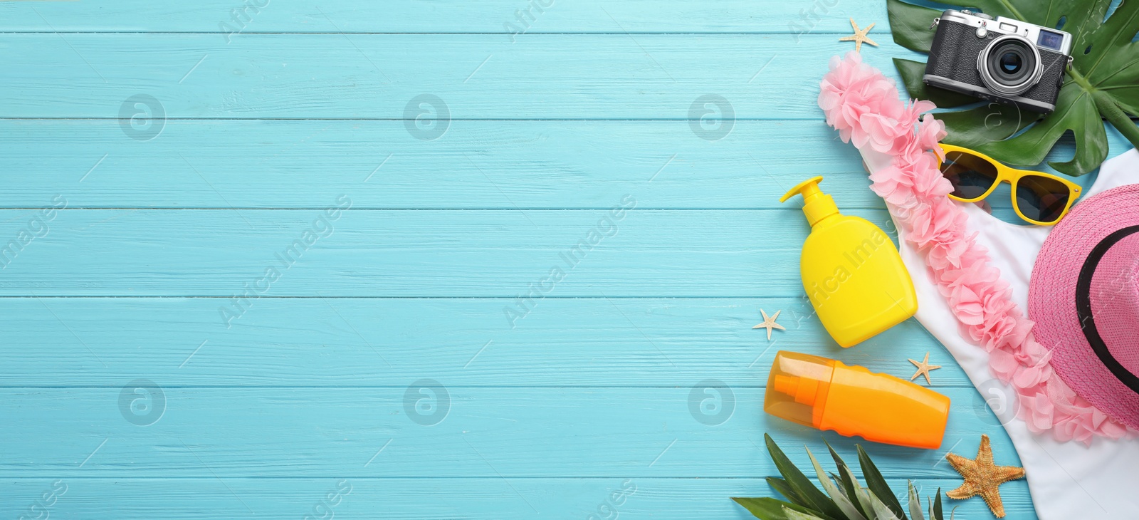 Image of Flat lay composition with beach accessories on light blue wooden background, space for text. Banner design