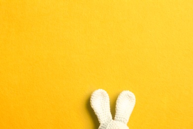 Photo of Easter bunny ears on color background, top view. Space for text