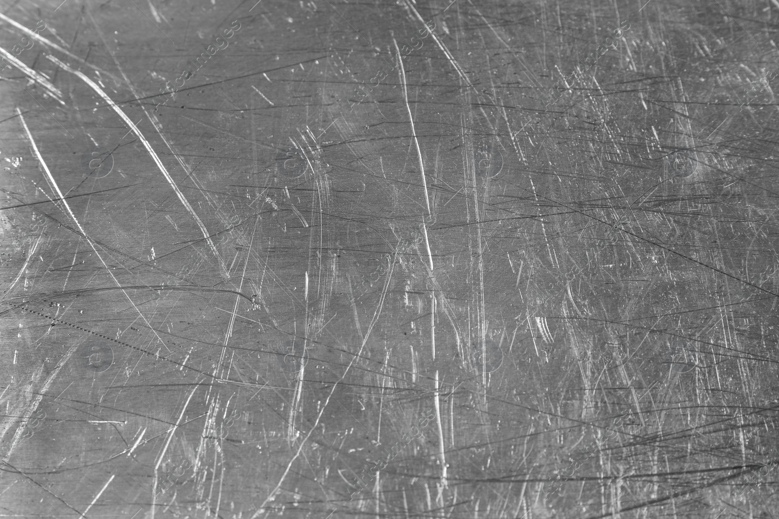 Photo of Texture of scratched metallic surface as background, closeup