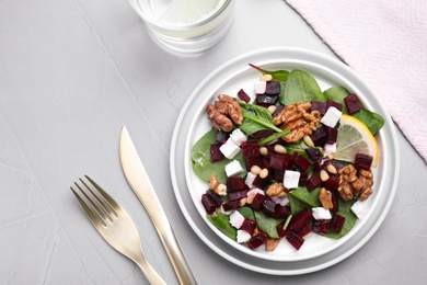 Delicious beet salad served on grey table, flat lay