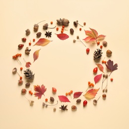 Frame made of autumn leaves on beige background, top view. Space for text