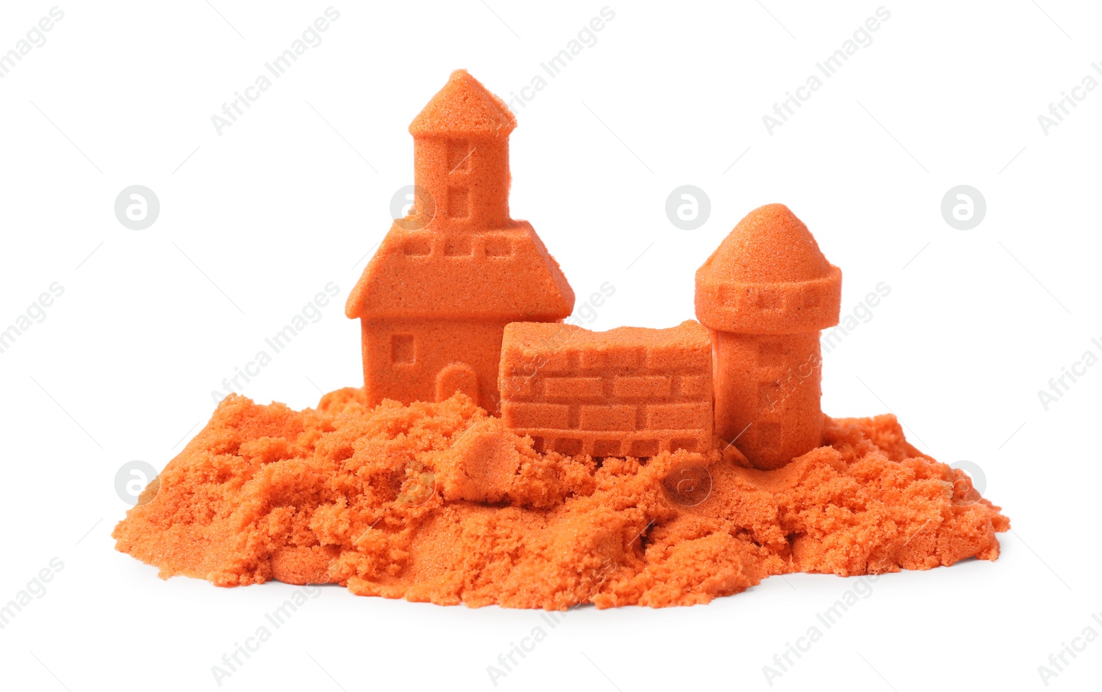 Photo of Castle figures made of orange kinetic sand isolated on white