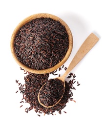 Bowl and spoon with uncooked black rice on white background, top view