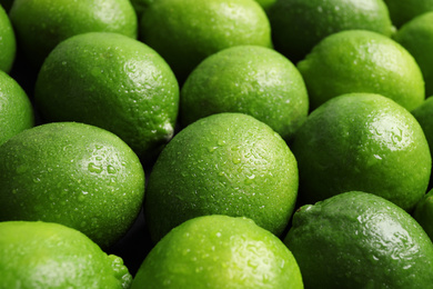 Photo of Fresh ripe juicy limes as background, closeup