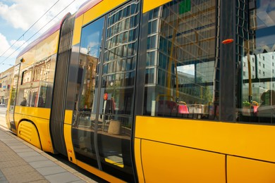 Photo of Streetcar on road in city, closeup. Public transport