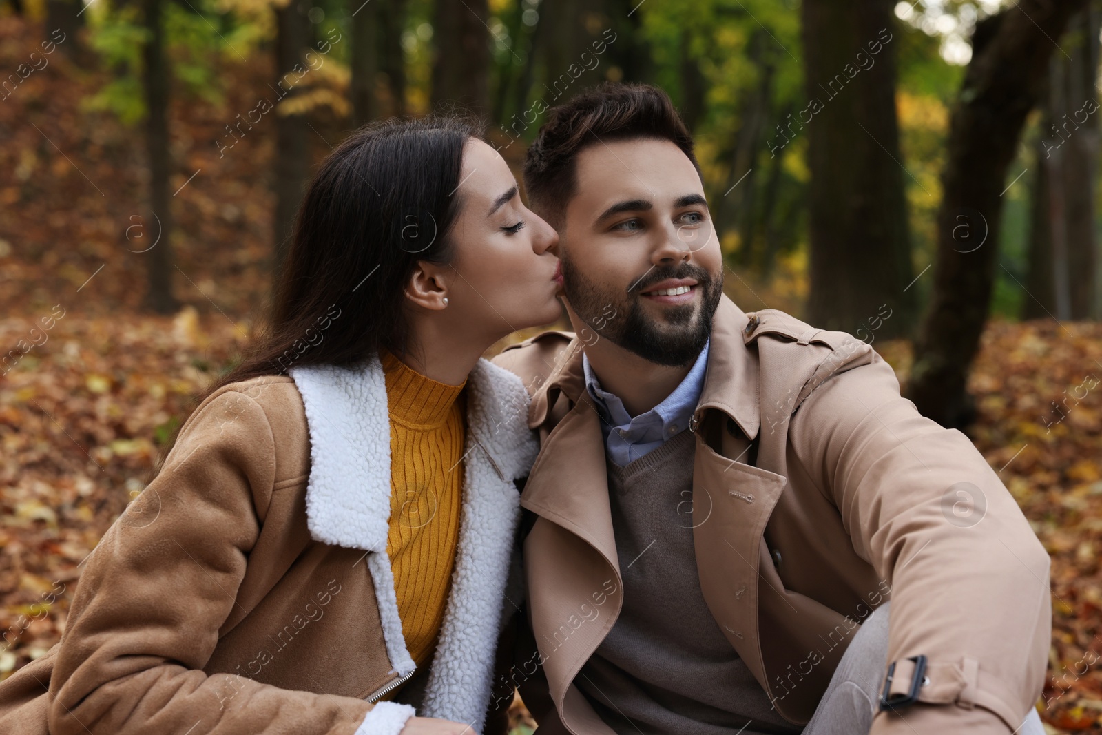 Photo of Happy young couple spending time together in autumn park