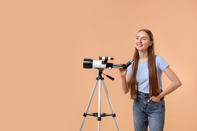 Happy astronomer with telescope on beige background, space for text